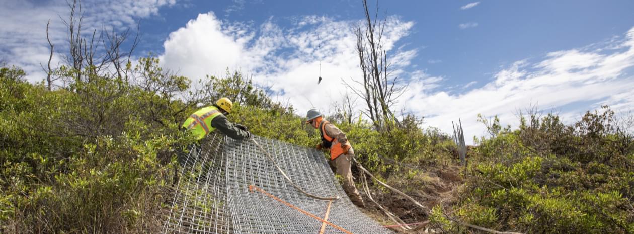 Workers prepping fence loads